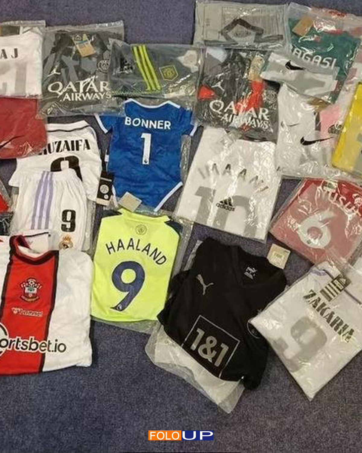 Counterfeit football shirts in plastic packaging after seizure
